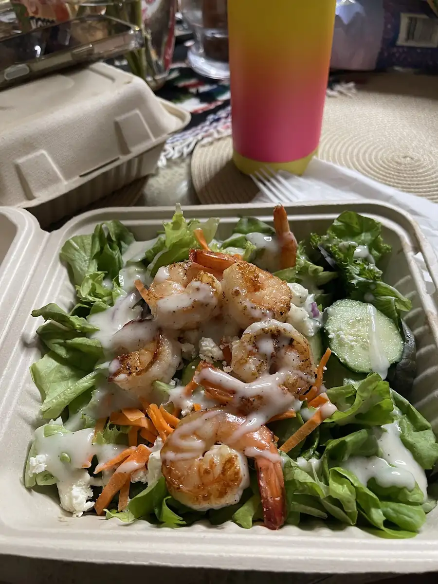 Green salad topped with shrimp